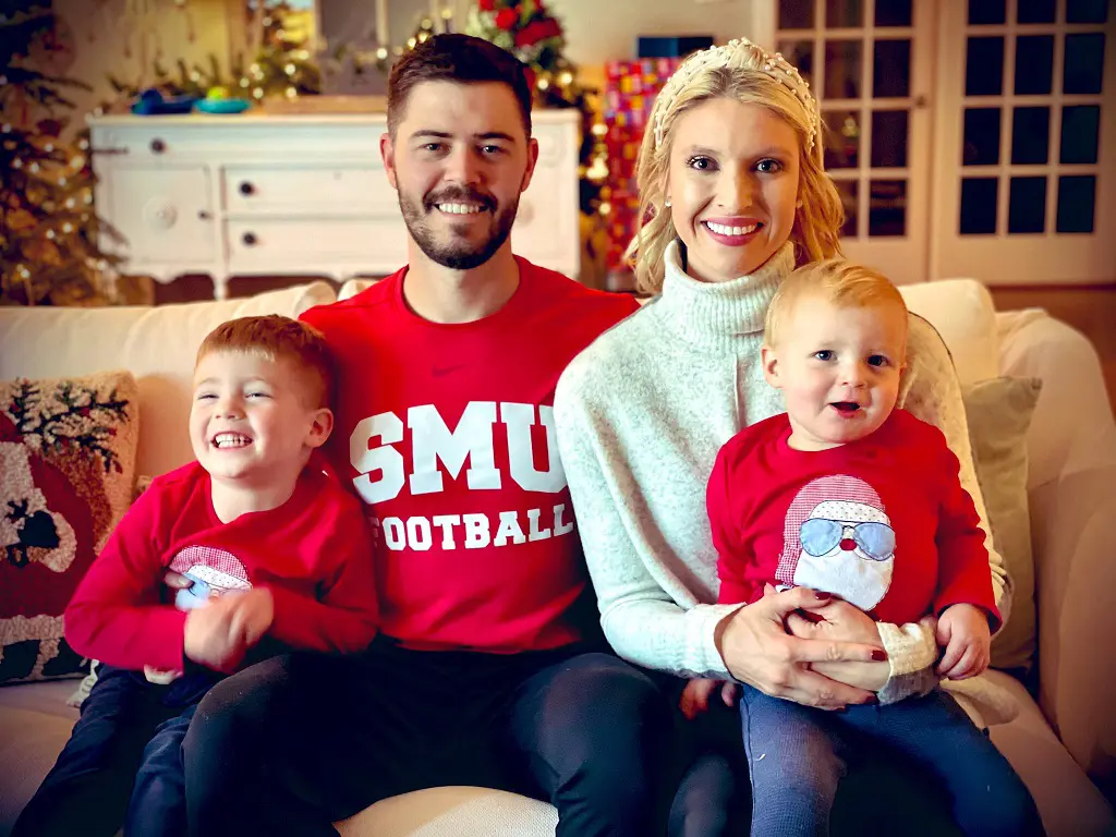 This image shows Garrett enjoying the holiday cheer with his wife and sons, Gibson and Greyson.