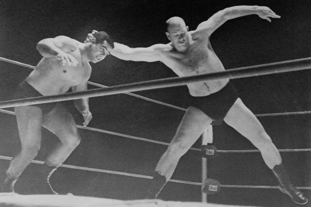 Fritz Von Erich prepares to throw Buddy Marino to the mat in their match. 