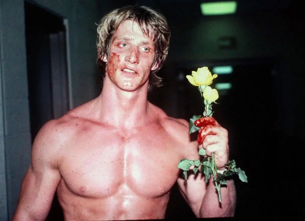 Kevin Von Erich clutching a yellow rose symbolizing his fallen brother David. 