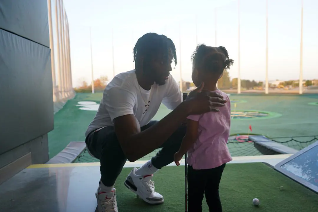 Justin and his daughter spending time at topgolf.