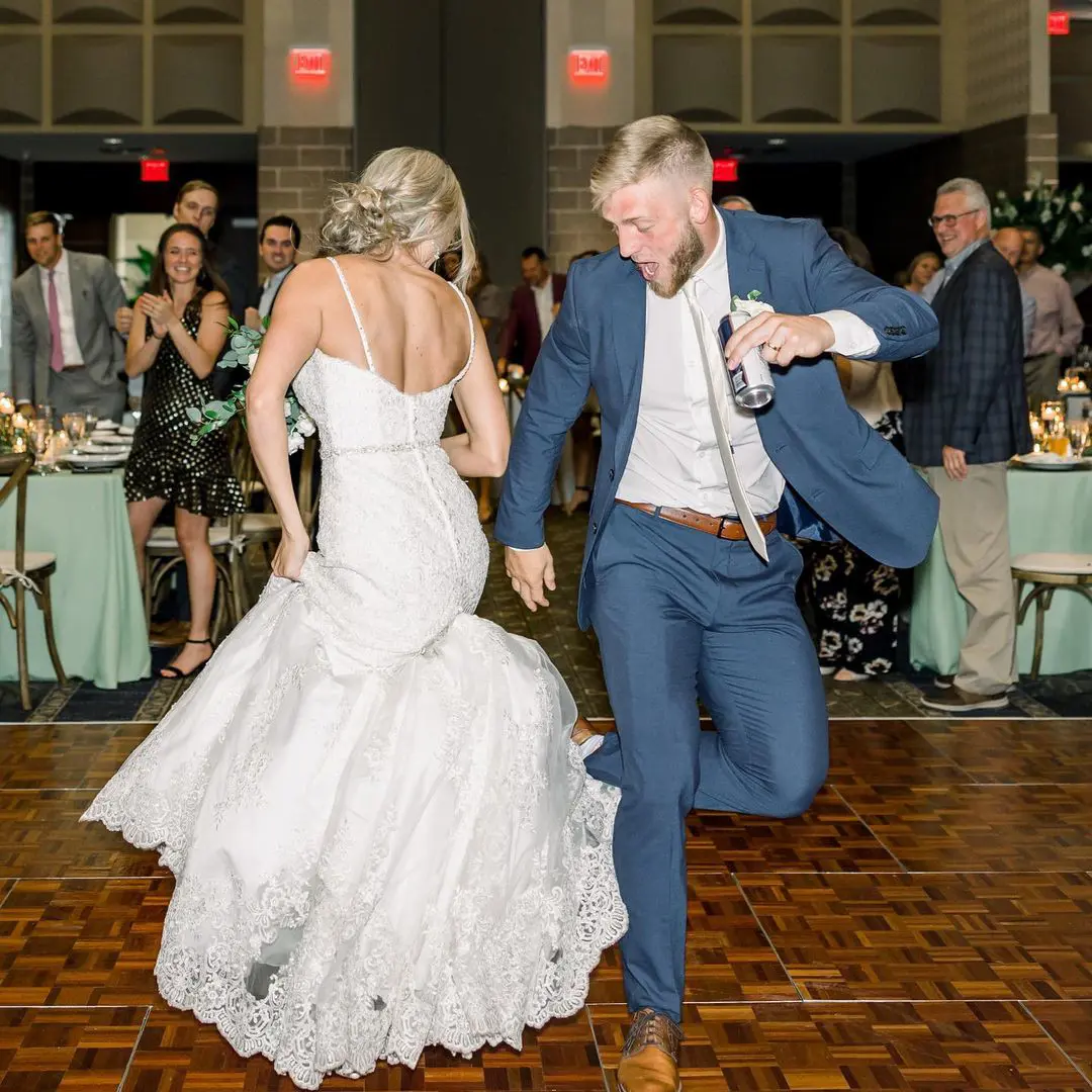 Jake and Hailey dancing and enjoying at their wedding among their friends and families.