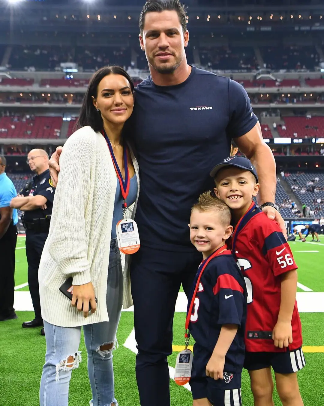 Brian and Megan with their children in the football field. 