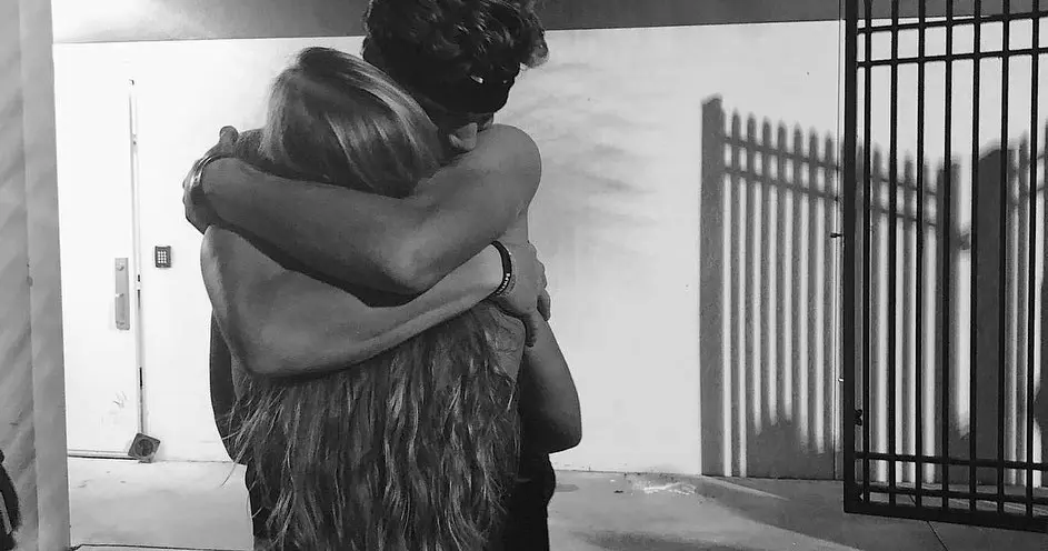 Picture of JJ McCarthy hugging his girlfriend  Katya Kuropas