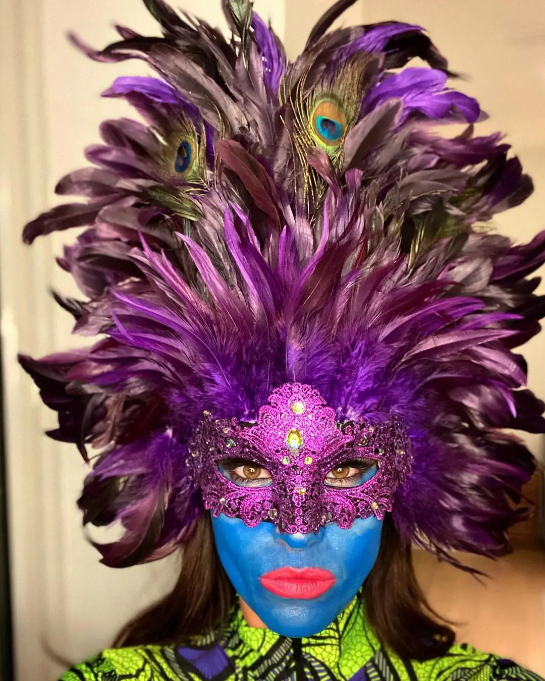 Emily with her face painted as a peacock.