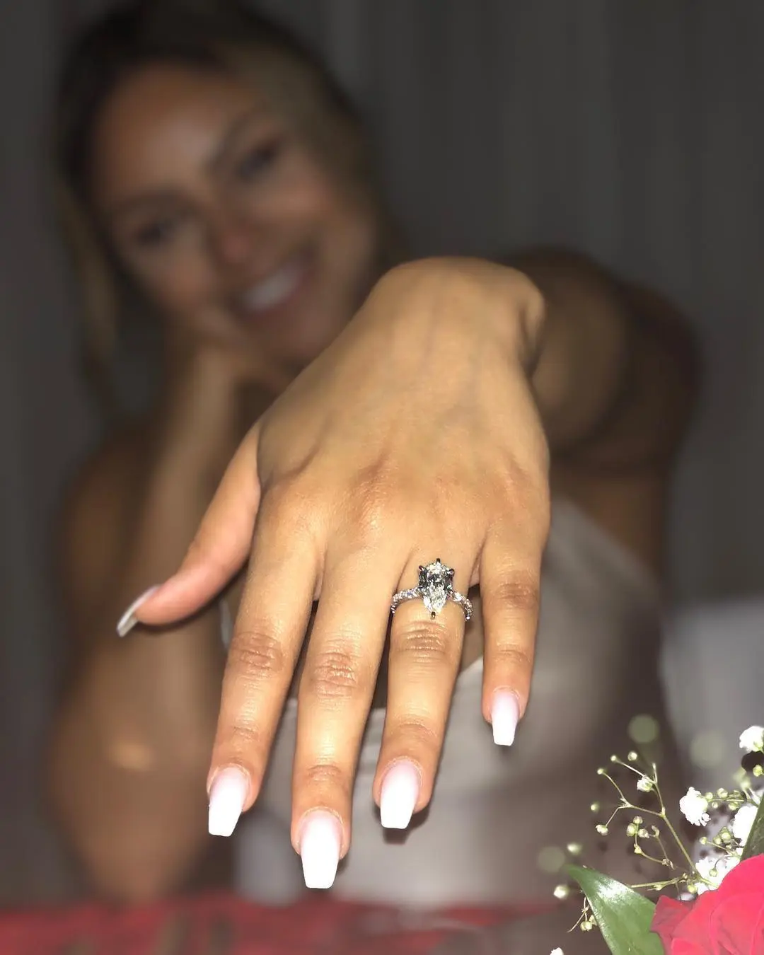 Neal's girlfriend turned fiancée displaying her engagement ring