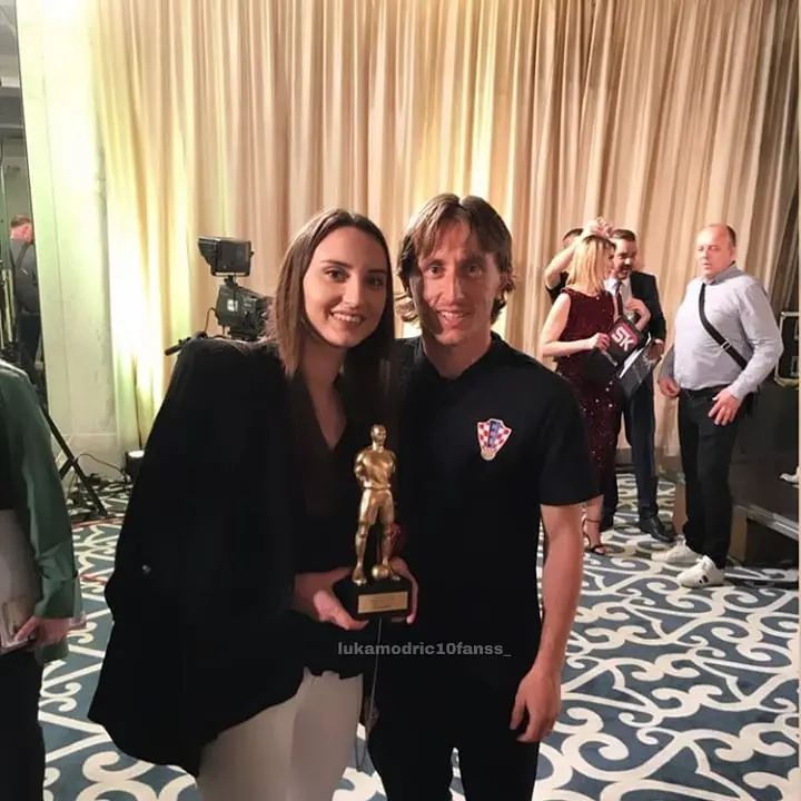 Diora Modric poses as she holds her brother's trophy.