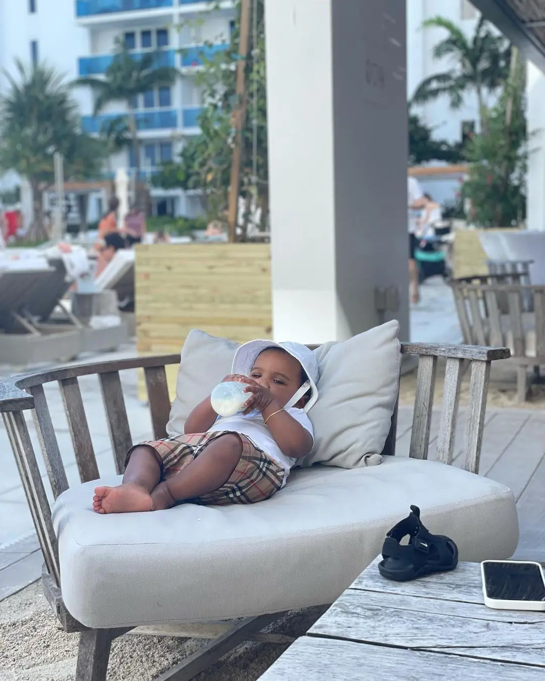 Photo of Keanu Neal baby relaxing in the sun and drinking milk