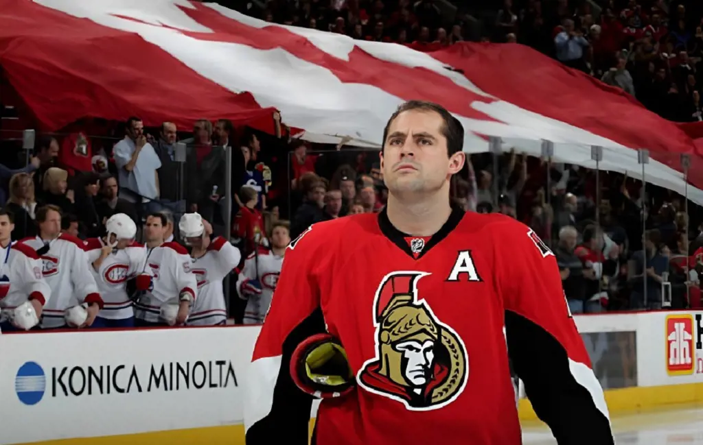 Senators' Chris Phillips during a game against the Canadiens at Scotiabank Place as a large Canadian flag is passed around the stands in January 2010