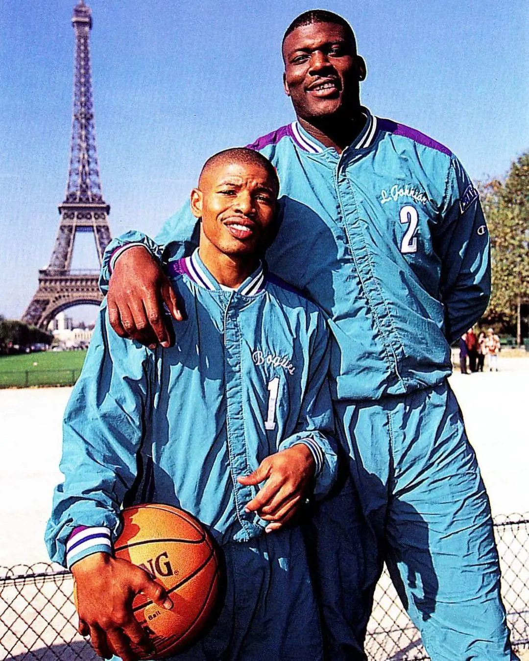 Larry and Muggsy Bogues striking a pose in front of Eiffel Tower in Paris