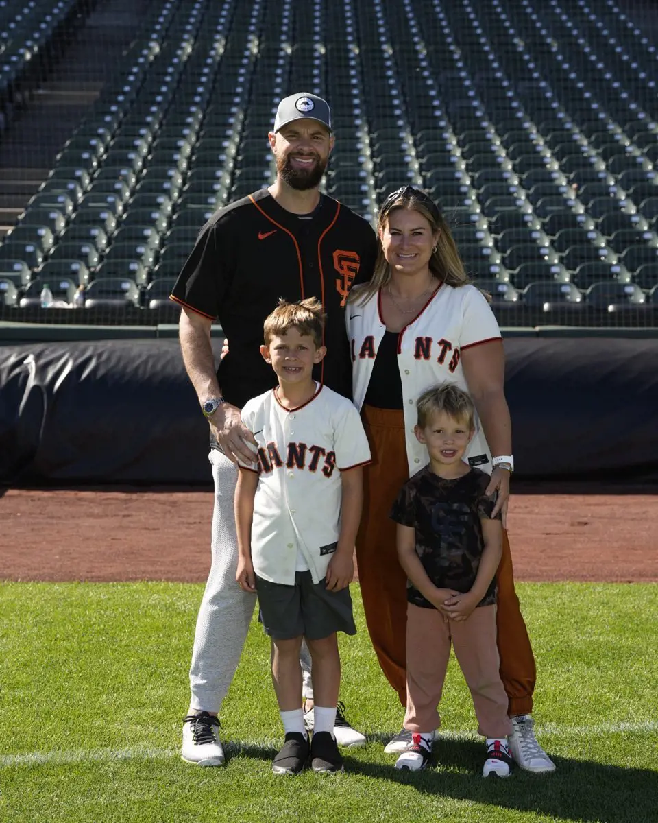 Brandon and Haylee with their children on a baseball field on Family day 2022 in July