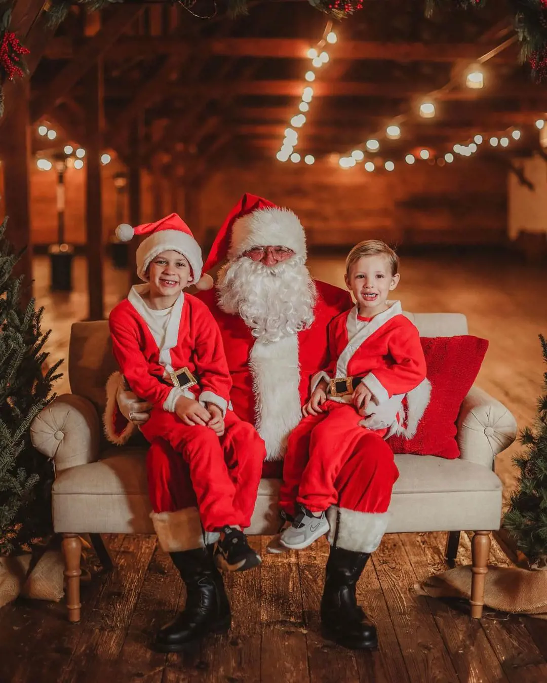 Greyson and August sitting on the lap of Santa Claus on Christmas day in December 2021