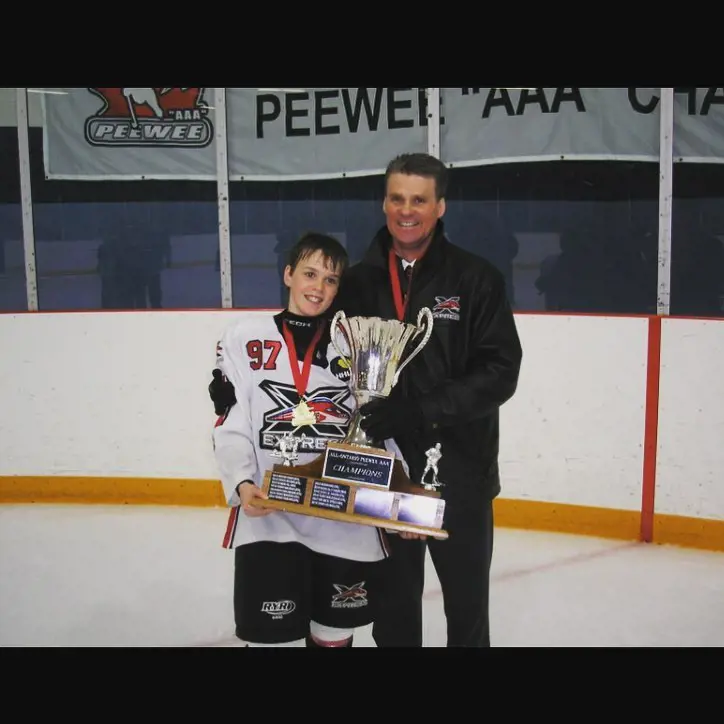McDavid with his dad holding his AAA junior level Championship 