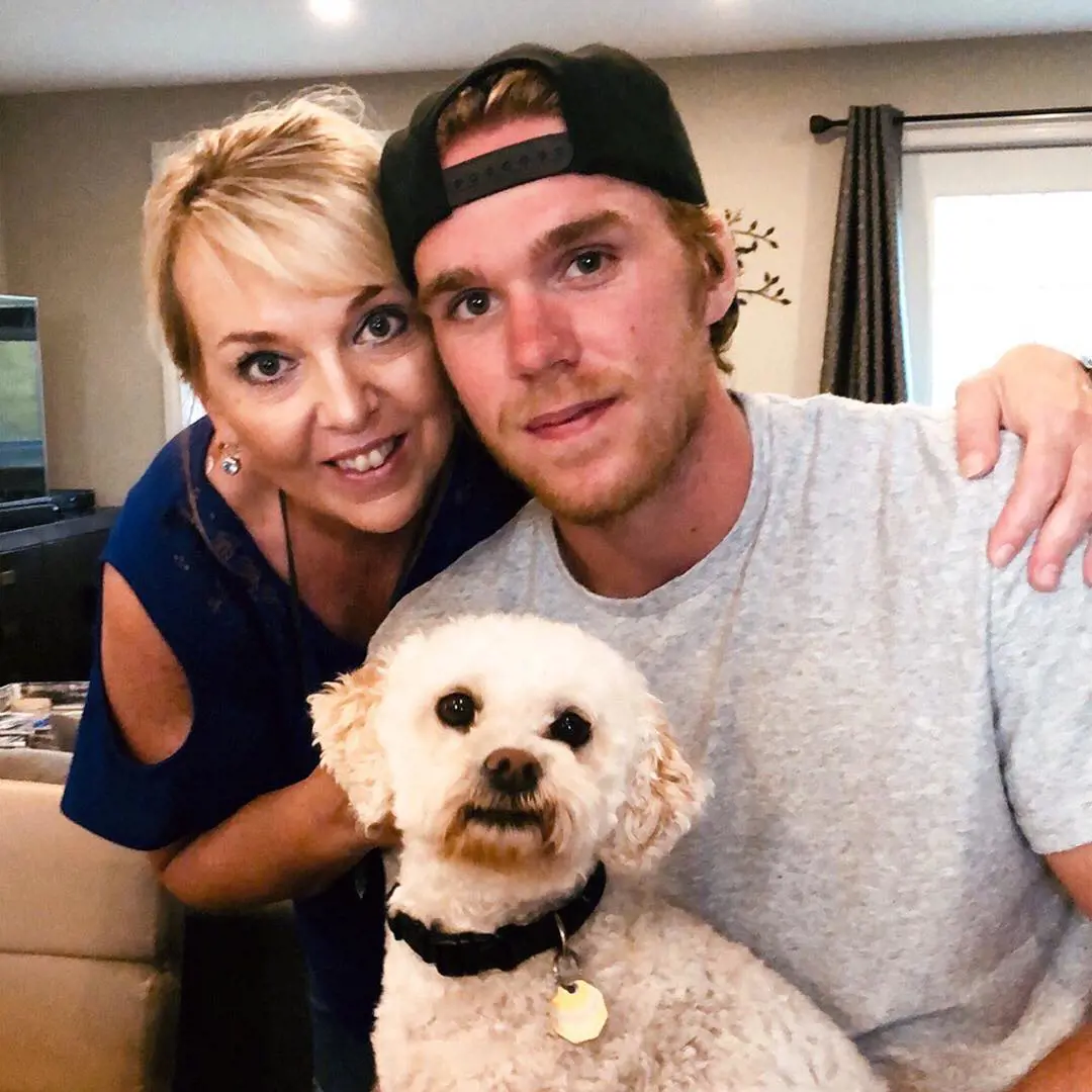 McDavid posing for a picture with his mother and their pet in December 2018