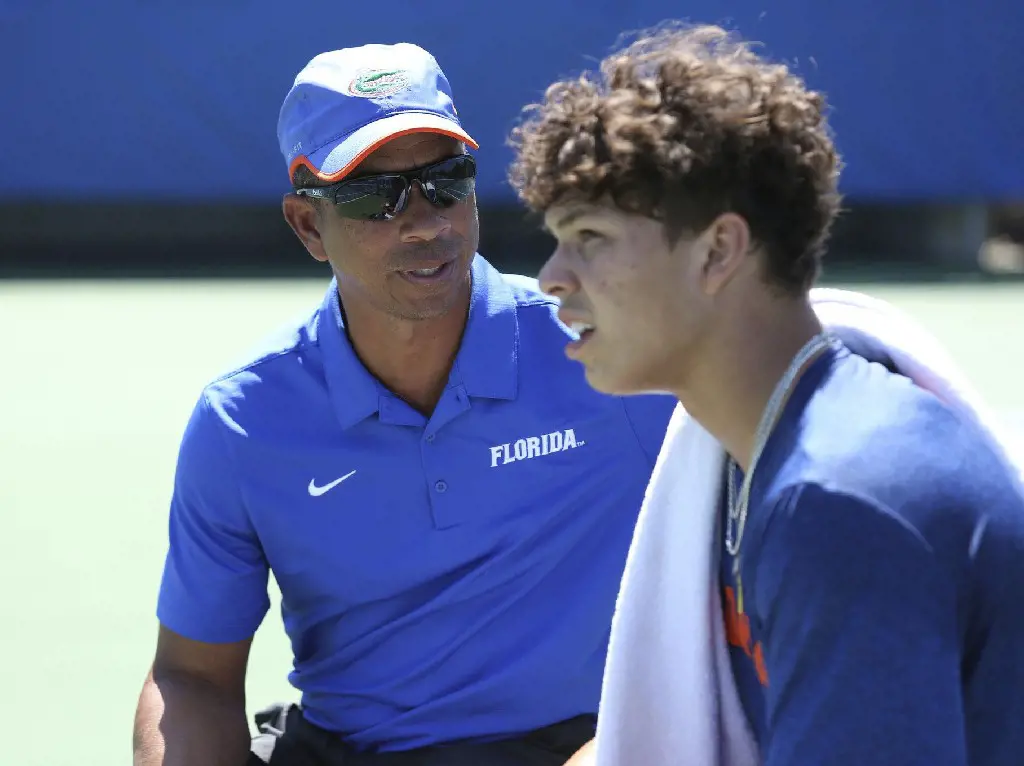Florida men's tennis coach Bryan Shelton (left) speaks to son Ben, the Gators' No. 1 player and nation's top-ranked singles player
