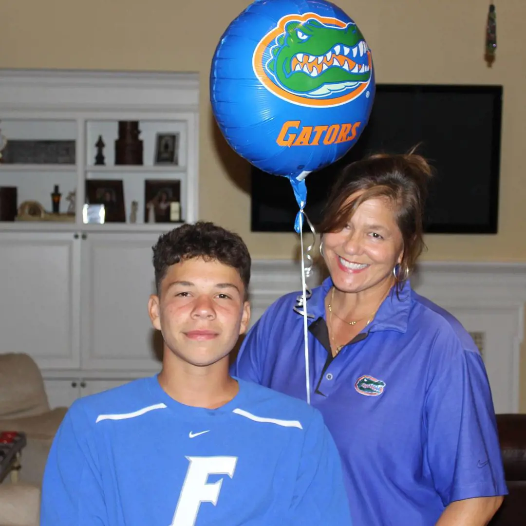 Ben's mother holding a Gators' balloon while Shelton signed his contract with the Florida Gators