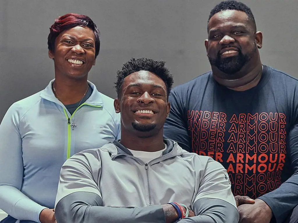 A 2019 snap of the NFL player DK Metcalf with his birthgivers before announcing his contract to Under Armour Football.