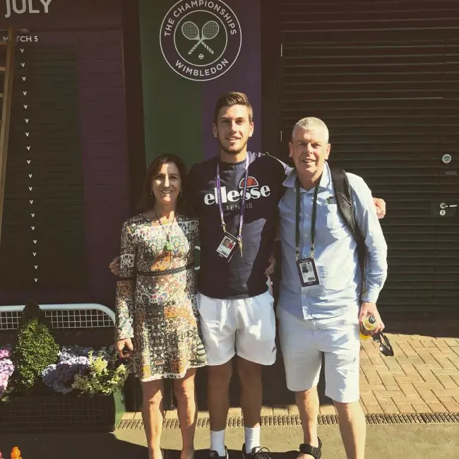 Cameron with his dad and mom at The All England Tennis Club who came to watch him play at Wimbledon in July 2017.