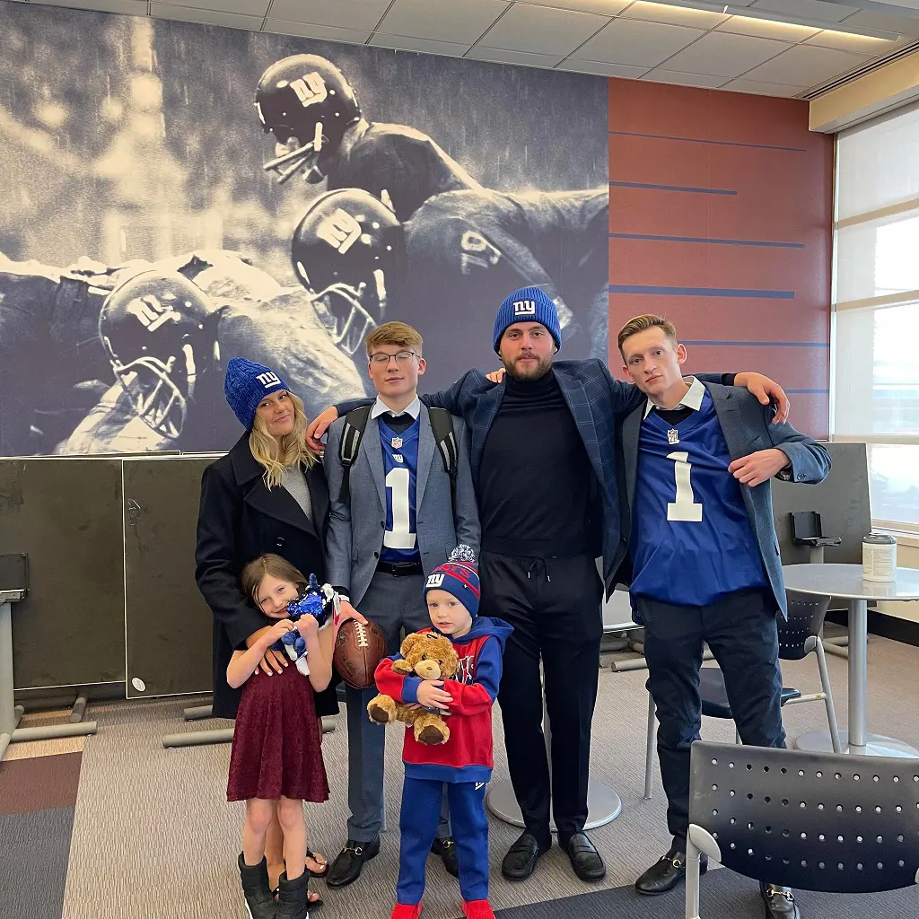 Christian, Haven, Mark, Adien, Avery, and Luke together supporting their dad's team New York Giants..
