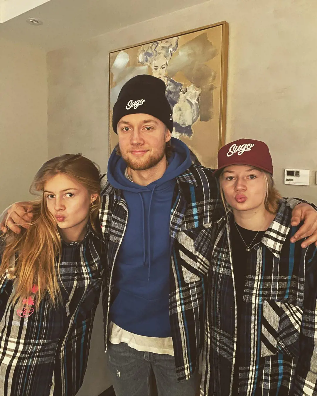 Alex poses for a photo with his sisters in a similar jacket in January 2020