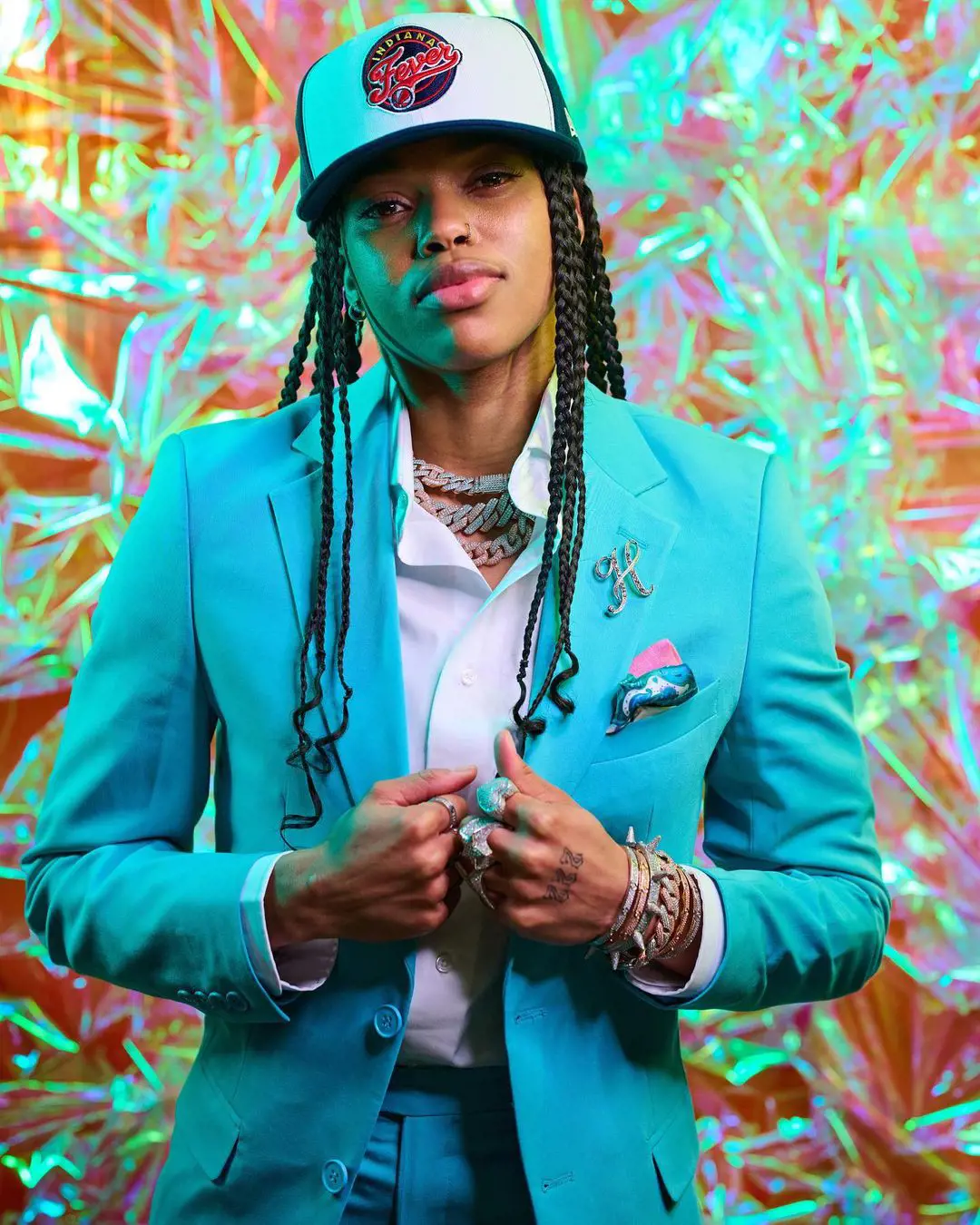 Henderson in a stylish Turquoise color suit in April 2022