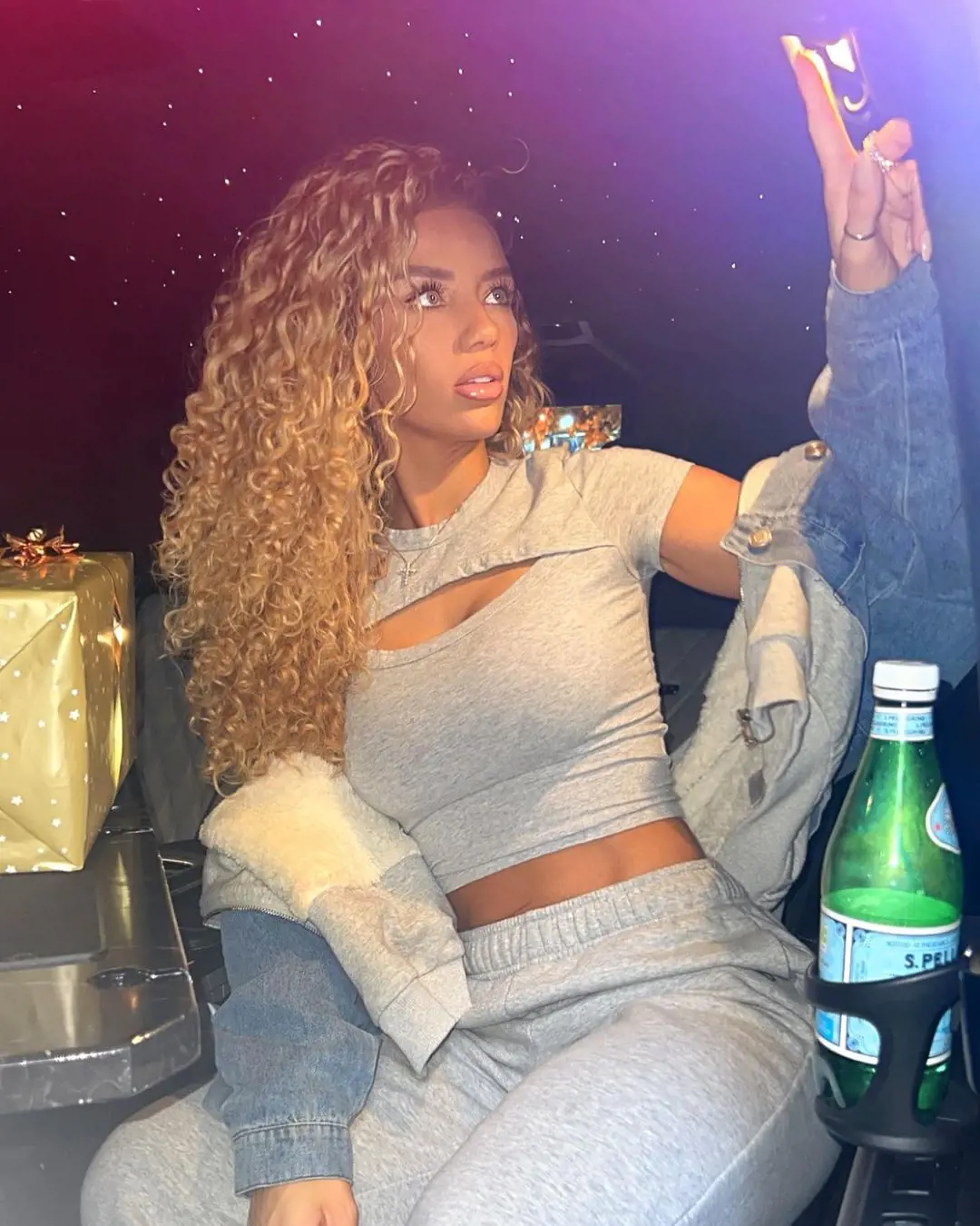 Jena Frumes on her England tour in December 2022, sitting in a car on the streets of Manchester. Silk Executive Travel arranged all her travel to UK