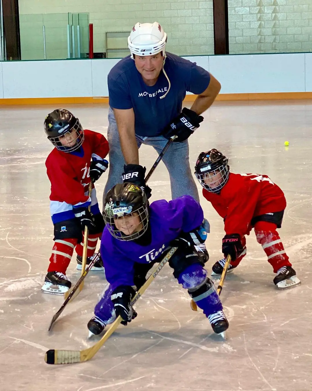 Eric playing hockey with his children.