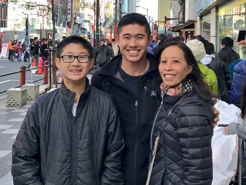 Morikawa and his brother with their Mom, Debbie in the street of Japan