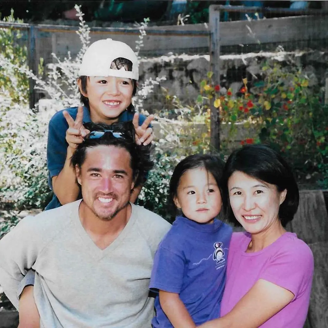 Taro pictured with his mom, dad and sister at a young age. 