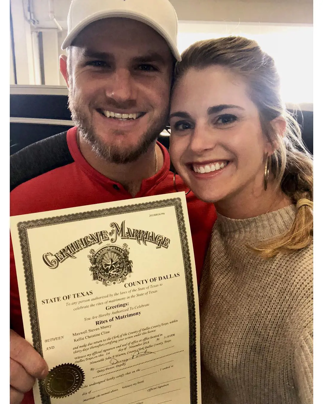 Kellie and Max holding their marriage license on November 2, 2018