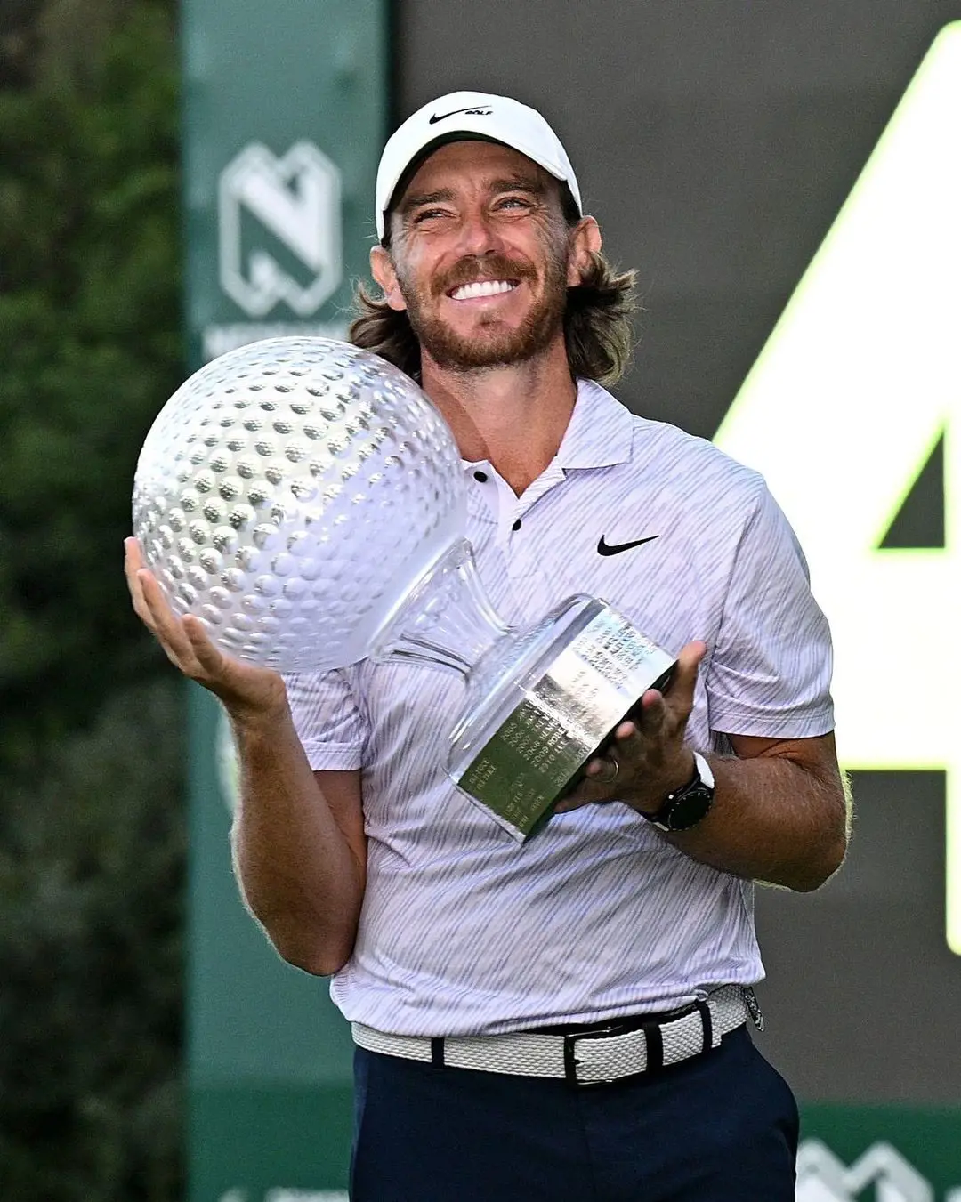 Tommy Fleetwood holding  his DP World Tour championship in November 2022
