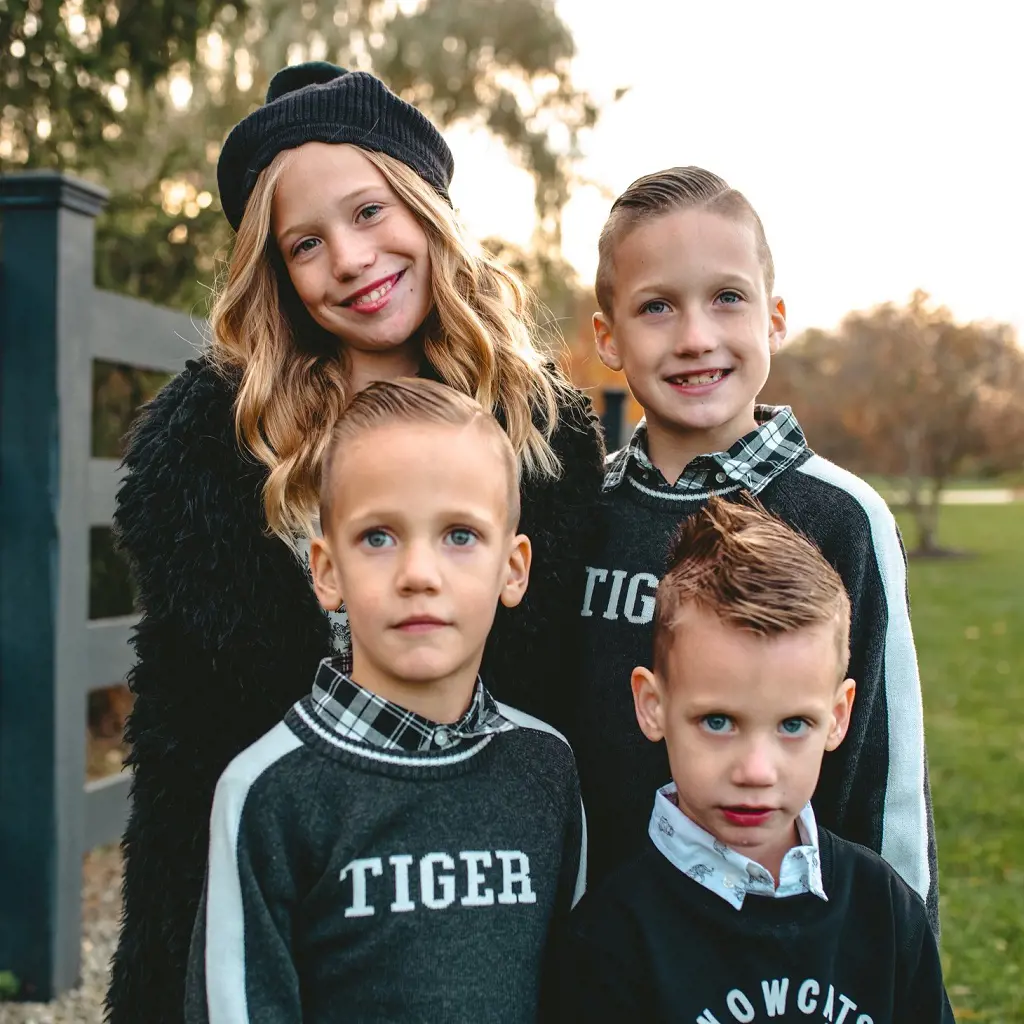 Hawk's four children donning tiger's sweater in April 2022