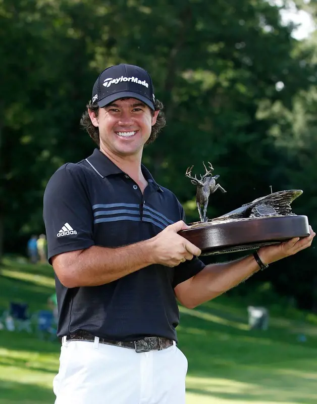 Brian Harman holds his John Deere Classic 2014 trophy with a big smile. 
