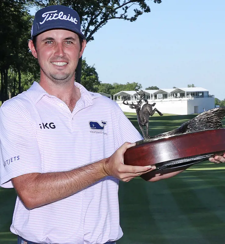 J.T. Poston holds his 2022 John Deere Classic trophy after the victory.