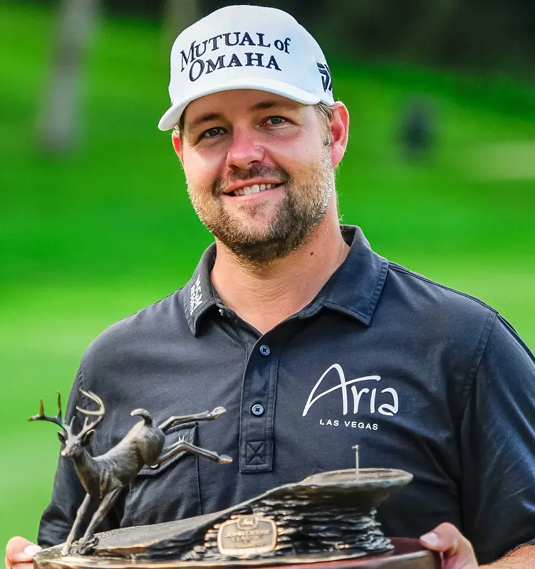 Ryan Moore holds his PGA Tour John Deere Classic trophy with a smile.