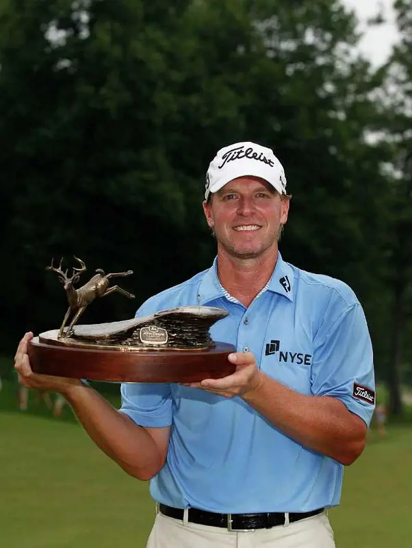 Steve Stricker holds his third John Deere Classic trophy after his 2011 win.