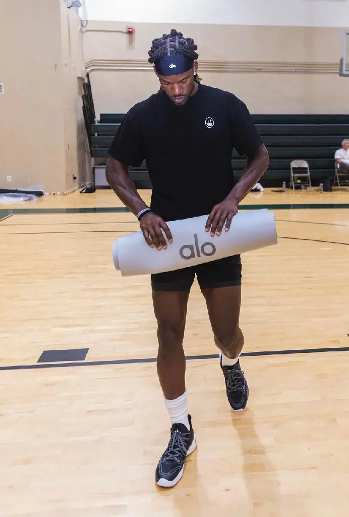 Butler during his practice session using Alo's head band and yoga mat in August 2022
