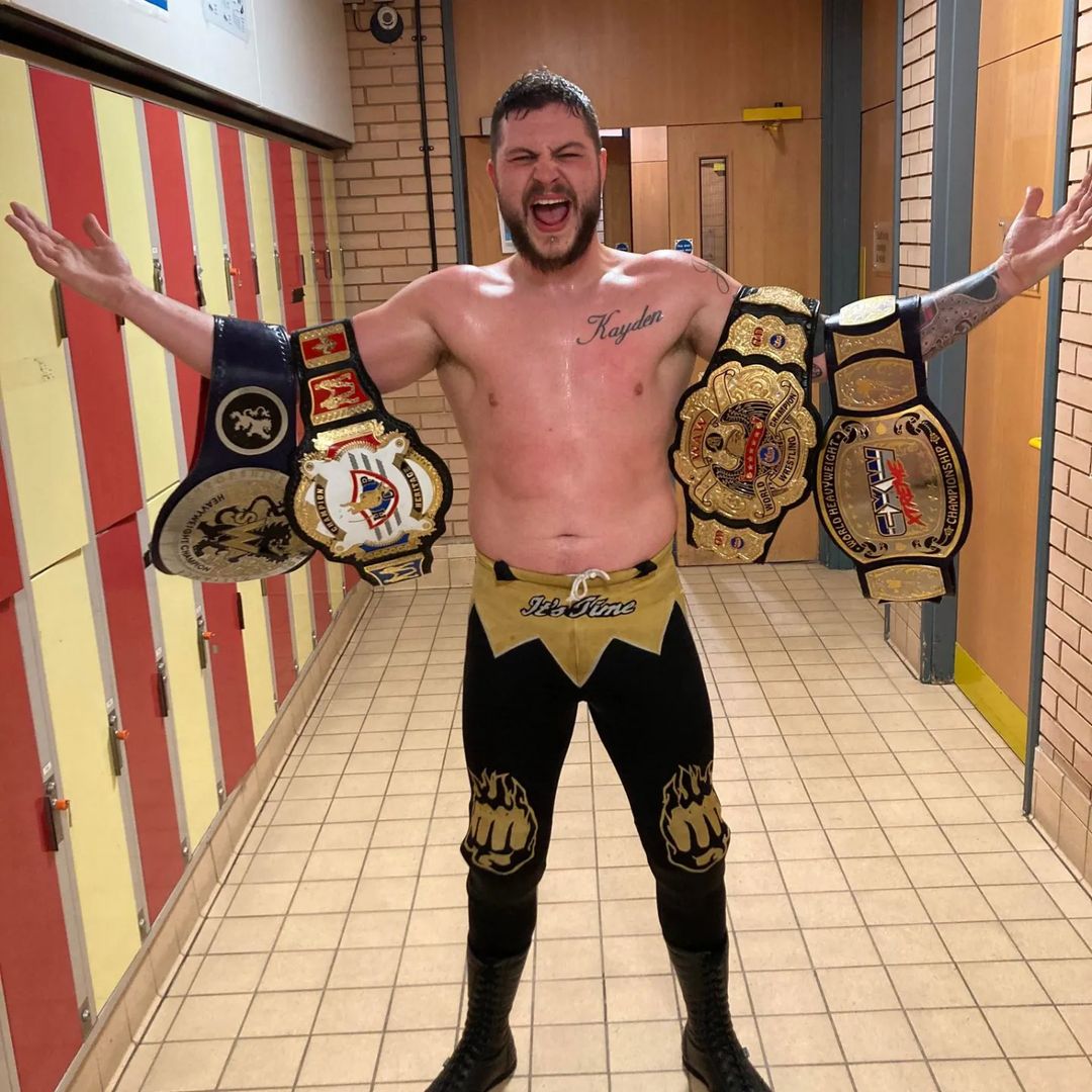 Zodiac proudly showcasing his championship belts in March 2022.