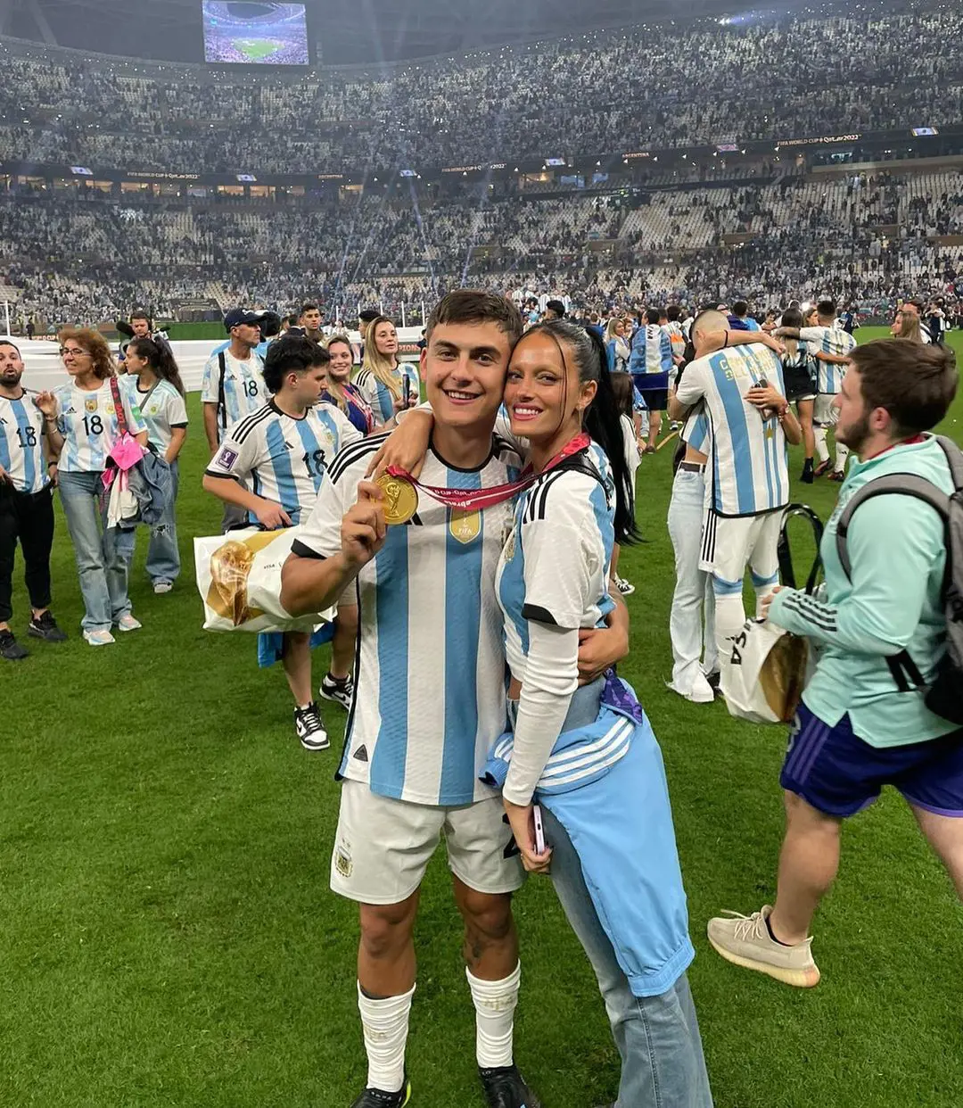 Paulo Dybala displaying the winner's medal with her WAG Oriana Sabatini after the World Cup win in December 2022
