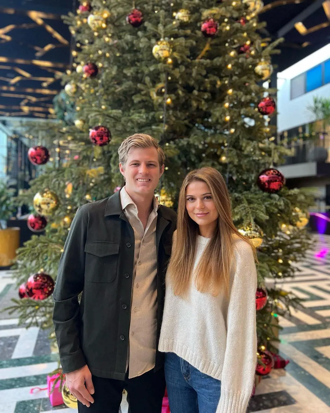 Marcus and Iris striking a pose in front of an Xmas tree during 2022 Christmas in Copenhagen