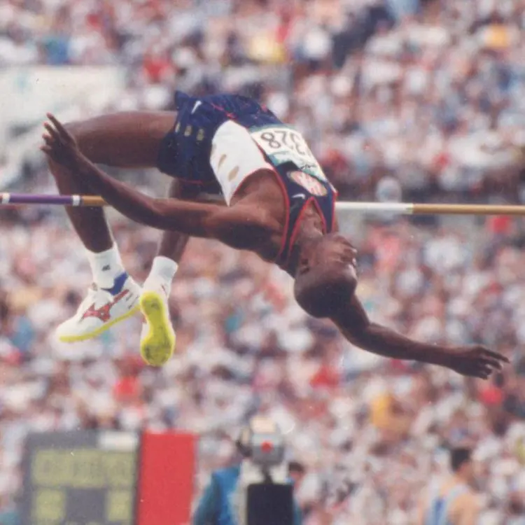 Charles Austin is pictured leaping over the bar as he shares the throwback picture on his Instagram handle
