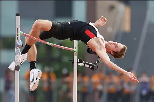 Derek Drouin pictured leaping over the bar as he is seen on action representing his nation Canada