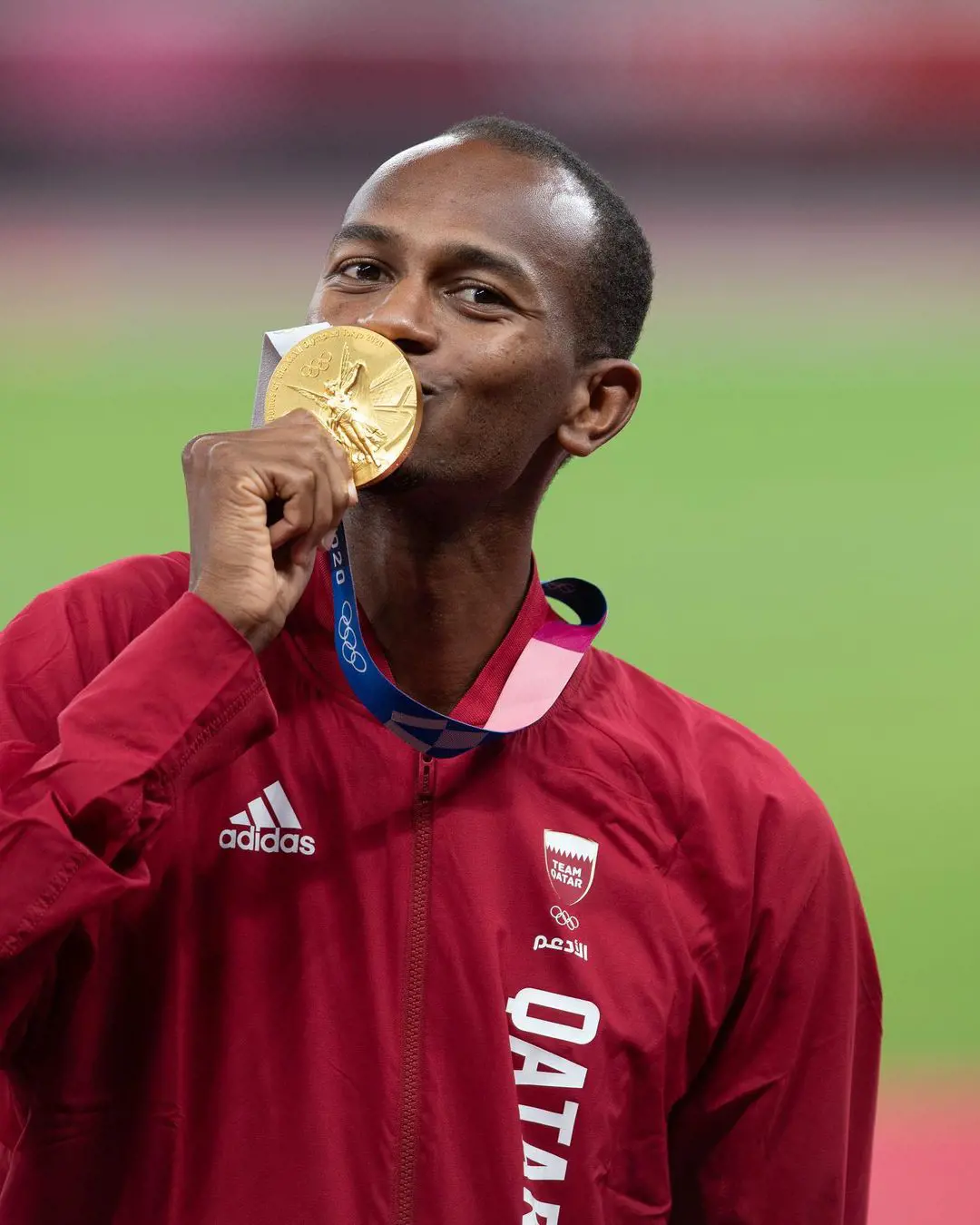 Mutaz Essa Barshim pictured kissing his gold medal as he shares the position with Tamberi