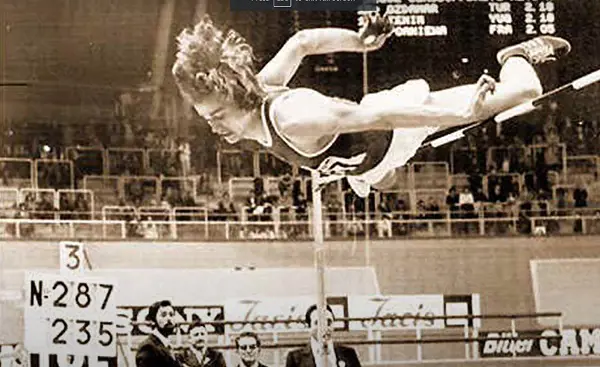 Vladimir Yashchenko pictured making the leap over the bar as the officials looks on using the straddle technique 