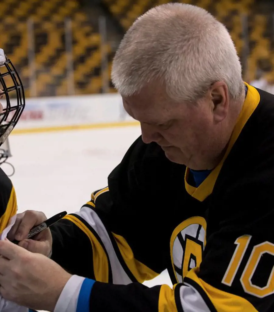 Bill signing an NHL player's jersey in 2014.