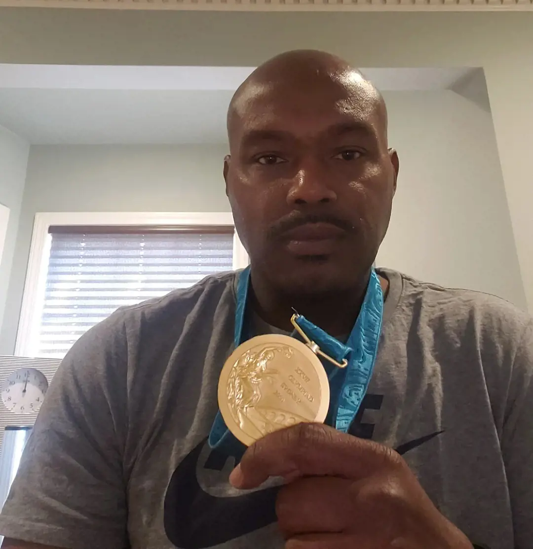 Tim showing off his 2000 Summer Olympics gold medal. 
